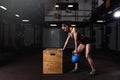 Young strong serious sweaty focused athlete fit muscular woman with big muscles holding heavy kettlebell weight barbell dumbbell Royalty Free Stock Photo