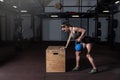 Young strong serious sweaty focused athlete fit muscular woman with big muscles holding heavy kettlebell weight barbell dumbbell Royalty Free Stock Photo