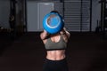 Young strong serious sweaty focused athlete fit muscular woman with big muscles holding heavy kettlebell weight barbell dumbbell Royalty Free Stock Photo