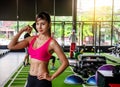 Young strong sexy woman showing her muscles on the arm in the gym Royalty Free Stock Photo