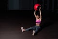 Young strong sweaty fit muscular girl with big muscles doing sit ups with medicine ball for abdominal muscles or abs hard workout Royalty Free Stock Photo