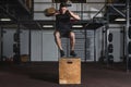 Young strong sweaty fit muscular man with big muscles doing box jump hardcore cross workout training in the gym real people Royalty Free Stock Photo