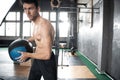 Young strong fit muscular man doing throwing medicine ball up on the wall for crossfit training hard core workout in gym Royalty Free Stock Photo