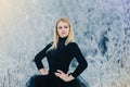 A young strong woman in black dress in winter forest Royalty Free Stock Photo