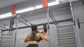 Young strong woman with perfect fitness body in sportswear exercising with medicine ball at gym. Girl doing crossfit Royalty Free Stock Photo