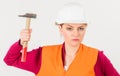 Young strong woman works as builder. Feminism concept. Royalty Free Stock Photo