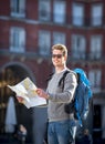 Young student backpacker tourist looking city map in holidays travel Royalty Free Stock Photo