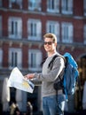 Young student backpacker tourist looking city map in holidays travel Royalty Free Stock Photo