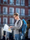 Young student backpacker tourist looking city map in holidays travel Royalty Free Stock Photo