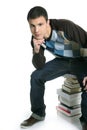 Young student boy sitting over stack books Royalty Free Stock Photo