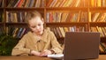 Young student in brown jacket writes lecture into notebook Royalty Free Stock Photo