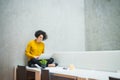 Young student or businesswoman sitting on desk in room in a library or office, using laptop. Royalty Free Stock Photo