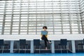 Young student or businesswoman sitting on desk in room in a library or office, using laptop. Royalty Free Stock Photo