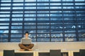 Young student or businesswoman sitting on desk in room in a library or office, using laptop. Royalty Free Stock Photo