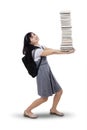 Young student carrying many books Royalty Free Stock Photo