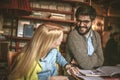 Young student couple helping etch other to study.