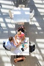 Young student couple holding hands while sitting at university library Royalty Free Stock Photo