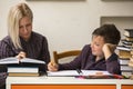 Young student doing homework with a tutor. Helping. Royalty Free Stock Photo