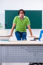 Young student doing physical exercises in the classroom