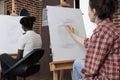 Young student drawing artistic vase on painting canvas