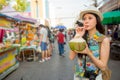 Young student drinking fresh coconut water Royalty Free Stock Photo