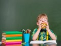 Young student eating a sandwich at lunchtime