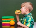 Young student eating a sandwich at lunchtime Royalty Free Stock Photo