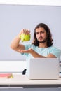 Young male student in expensive education concept Royalty Free Stock Photo