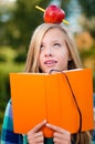 Young student girl with apple on her head Royalty Free Stock Photo