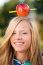 Young student girl with apple on her head Royalty Free Stock Photo