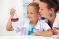 Young student girl in chemistry class with her teacher Royalty Free Stock Photo