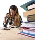 Young student girl concentrated studying for exam at college library education concept