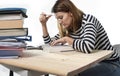 Young student girl concentrated studying for exam at college library education concept