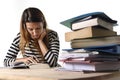 Young student girl concentrated studying for exam at college library education concept