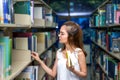Young Student Girl Finding Book in Classroom Royalty Free Stock Photo
