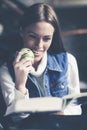 Young student girl at home learning and eating apple. Royalty Free Stock Photo