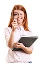 Young student girl looking through a magnifying glass Royalty Free Stock Photo