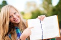 Young student girl showing something in book Royalty Free Stock Photo