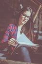 Young student girl sitting at home and reading homework. Royalty Free Stock Photo