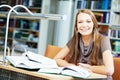 Young student girl study with book in library