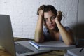 Young student girl studying tired at home laptop computer preparing exam exhausted and frustrated feeling stress Royalty Free Stock Photo