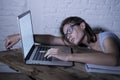 Young student girl studying tired at home laptop computer preparing exam exhausted and frustrated feeling stress Royalty Free Stock Photo