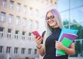 Young student girl using smart mobile phone to check social media platforms - Millennial influencer posting new content while Royalty Free Stock Photo