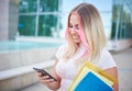 Young student girl using smart mobile phone to check social media platforms - Millennial influencer posting new content while Royalty Free Stock Photo