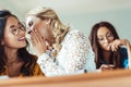 young student girls gossiping in class while classmate working hard Royalty Free Stock Photo