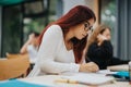 Focused students taking notes in a bright classroom setting Royalty Free Stock Photo