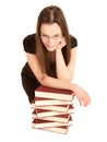 Young student with glasses and a pile of books Royalty Free Stock Photo