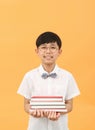 A young student holding a book and smiling happily with a bright expression Royalty Free Stock Photo