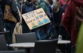 Young student holding cardboard sign with German text that means Act Now Before It Is Too Late on a Fridays for future