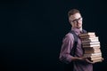 Student Holding a Pile of Books and Gives a Sceptical Look